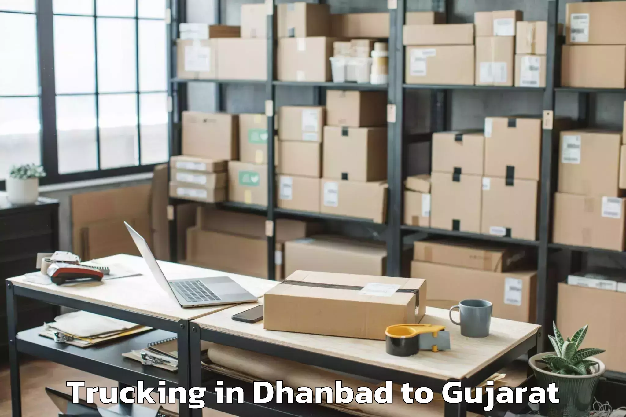 Book Dhanbad to Uchchhal Trucking Online